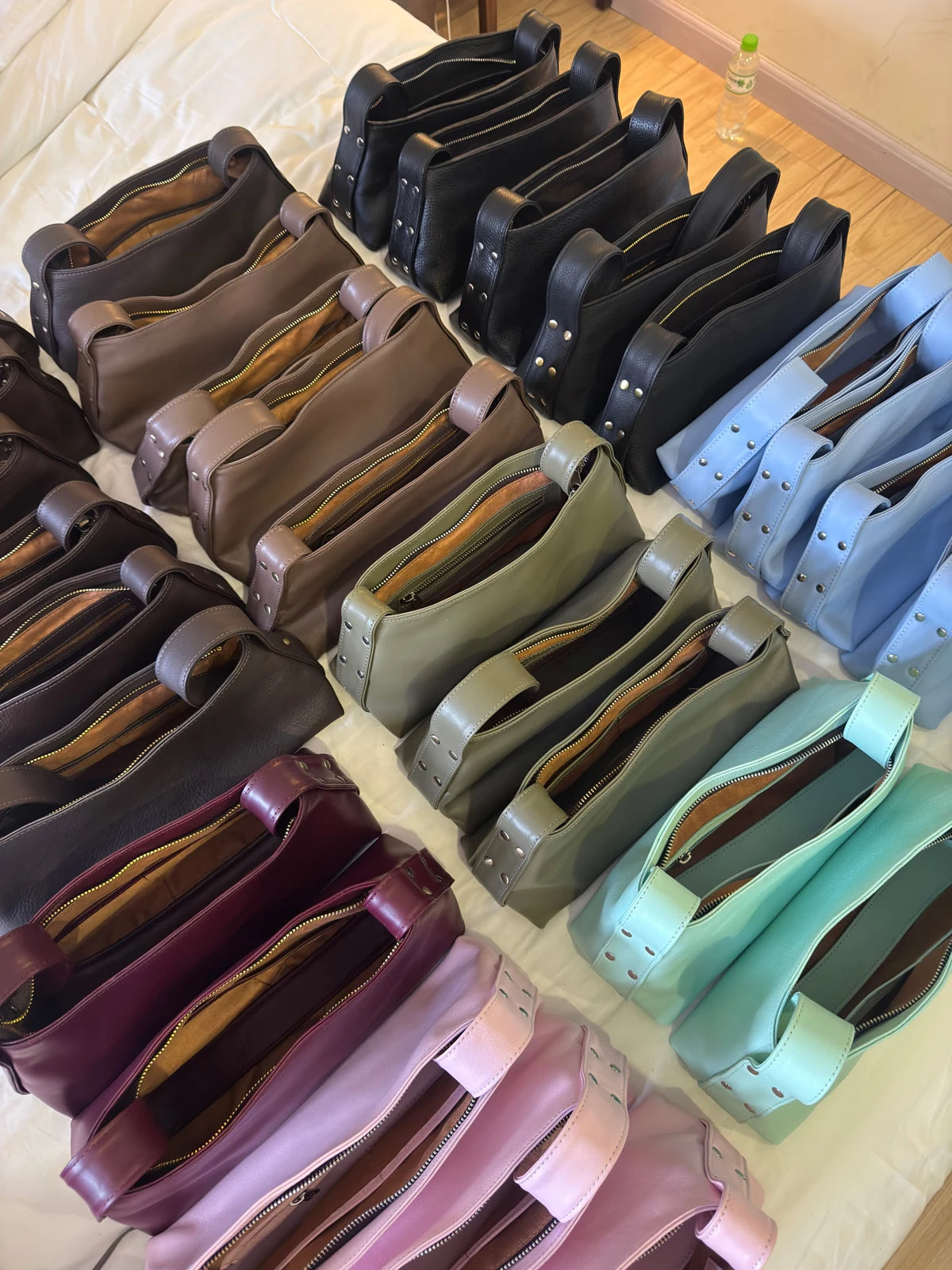 KÖVI leather handbags arranged in a range of colours
