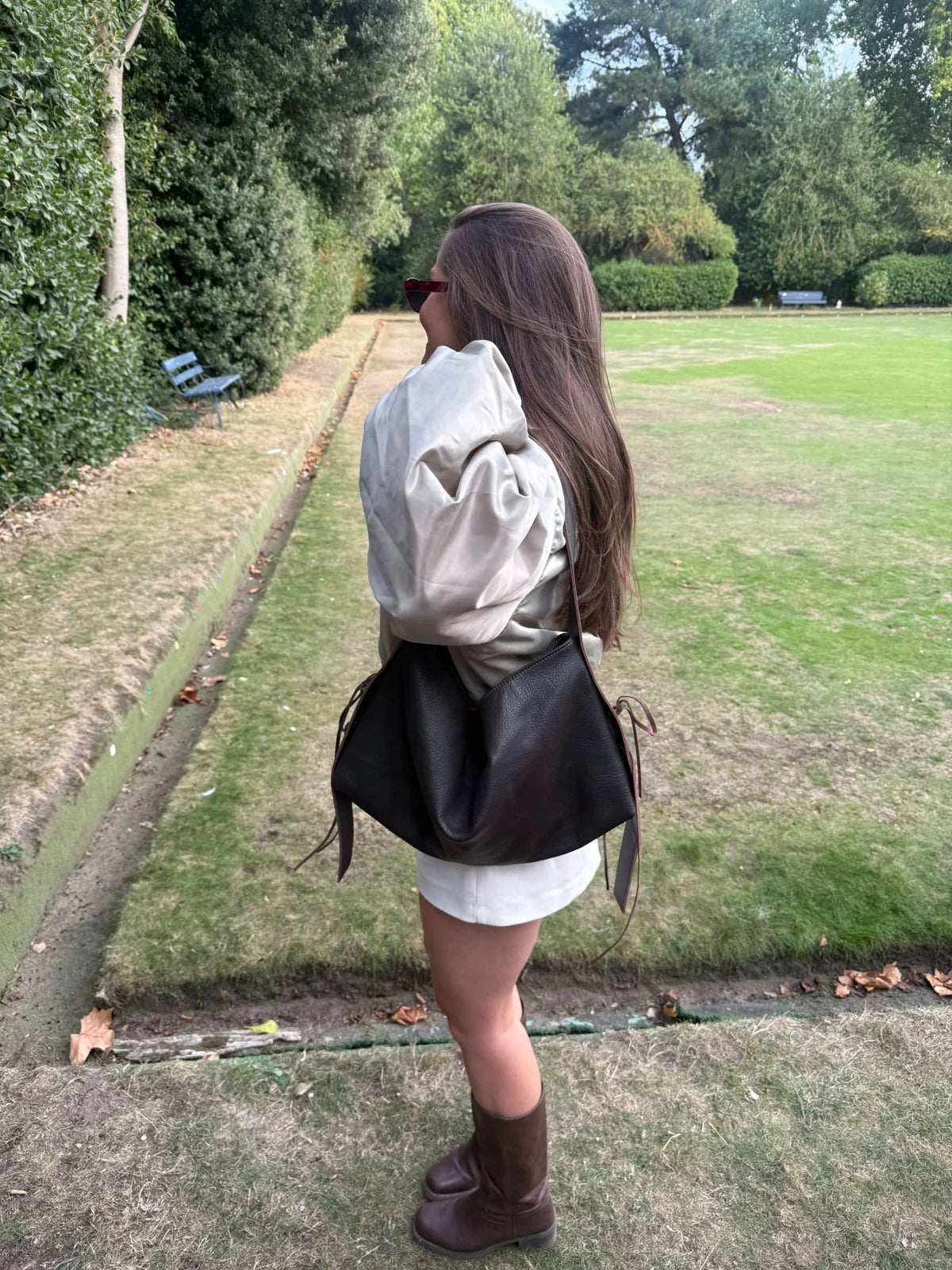 A black KÖVI bag worn on a walk outdoors